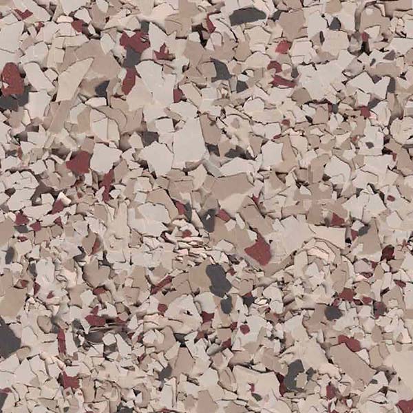 The image shows a textured surface comprising an assortment of irregularly shaped particles in various shades of beige, pink, and deep red, likely a granular material.