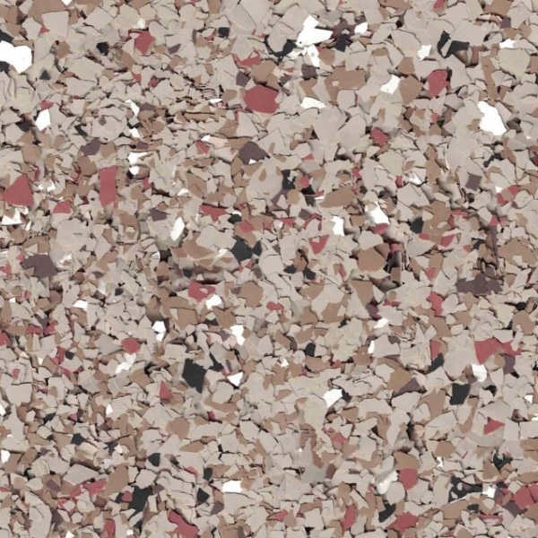 This image shows a multitude of irregularly shaped particles in various shades of brown, beige, white, and dashes of red, closely packed together in a mosaic pattern.