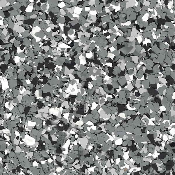 The image shows a multitude of small, irregularly shaped fragments in shades of gray, black, and white, densely compacted to form an abstract mosaic.